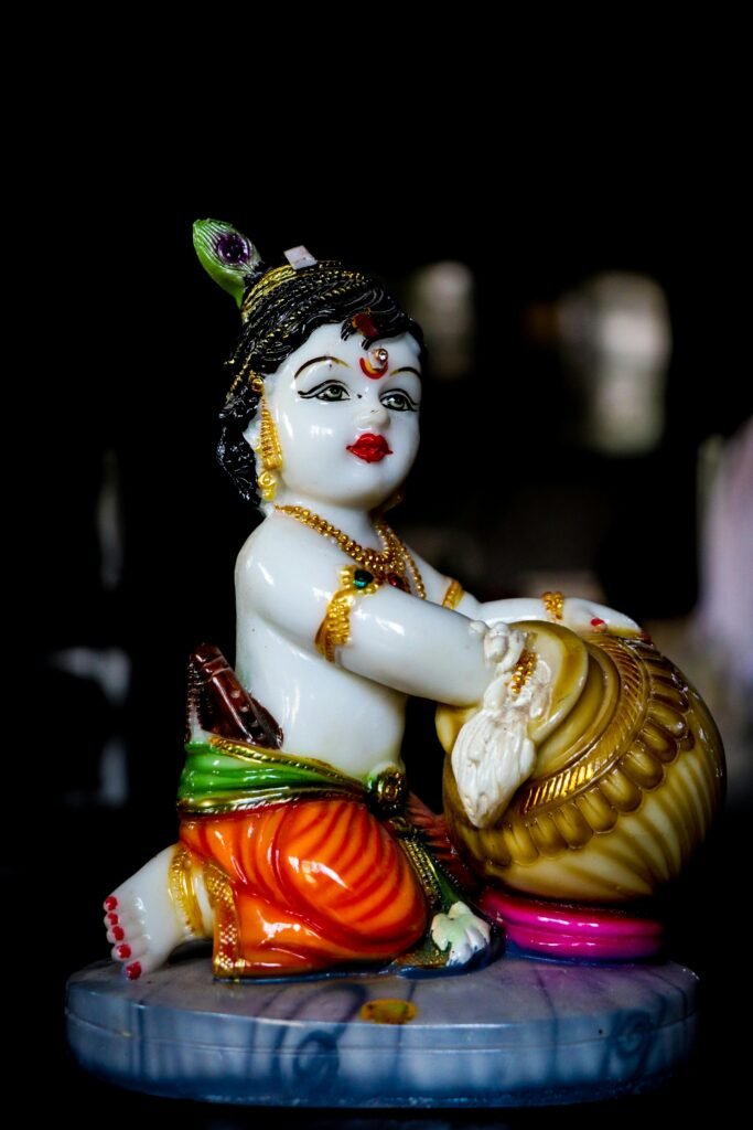 Vivid close-up of a vibrant porcelain Krishna figurine highlighting intricate design and color.